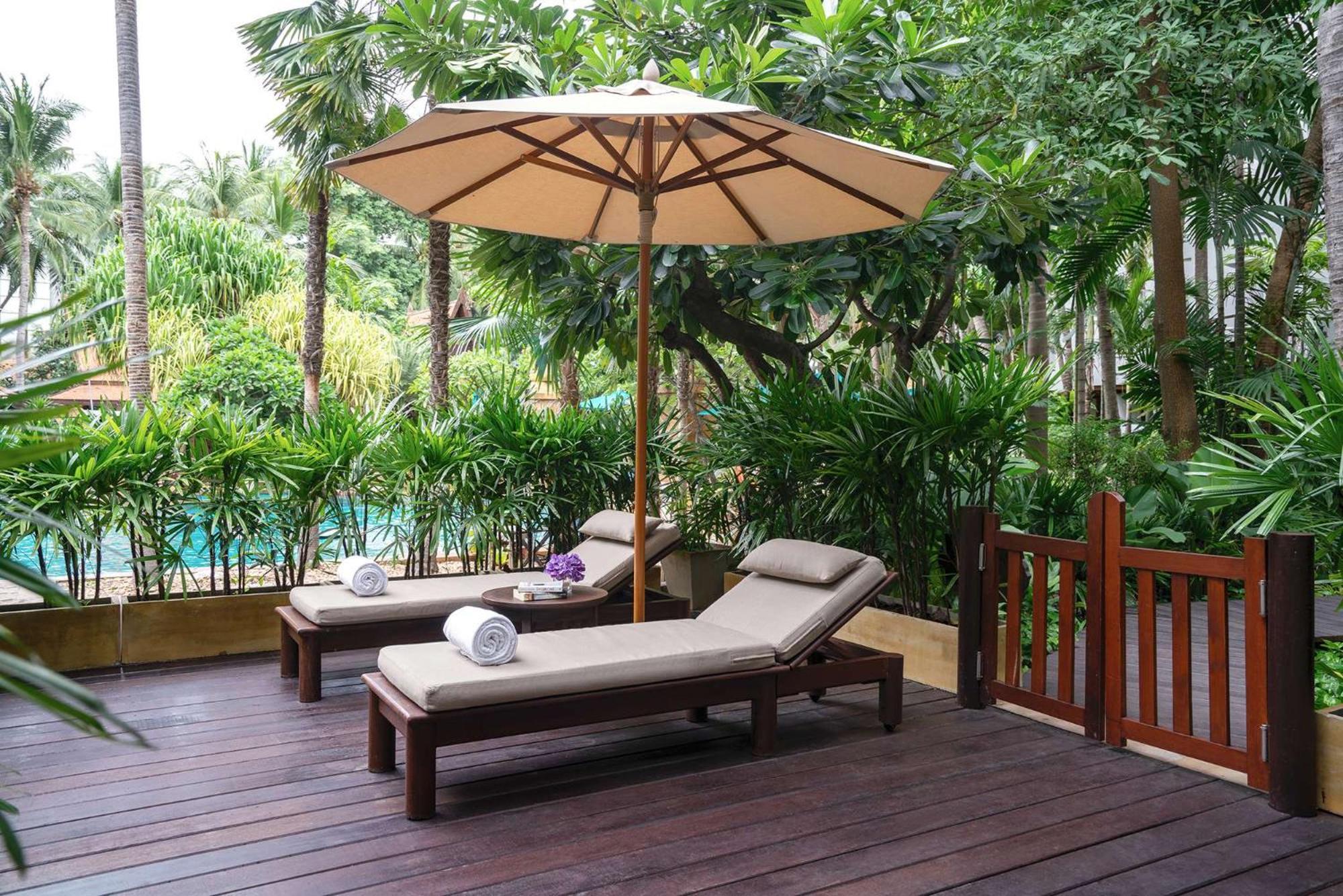 Avani Pattaya Resort Exterior photo A patio with a parasol